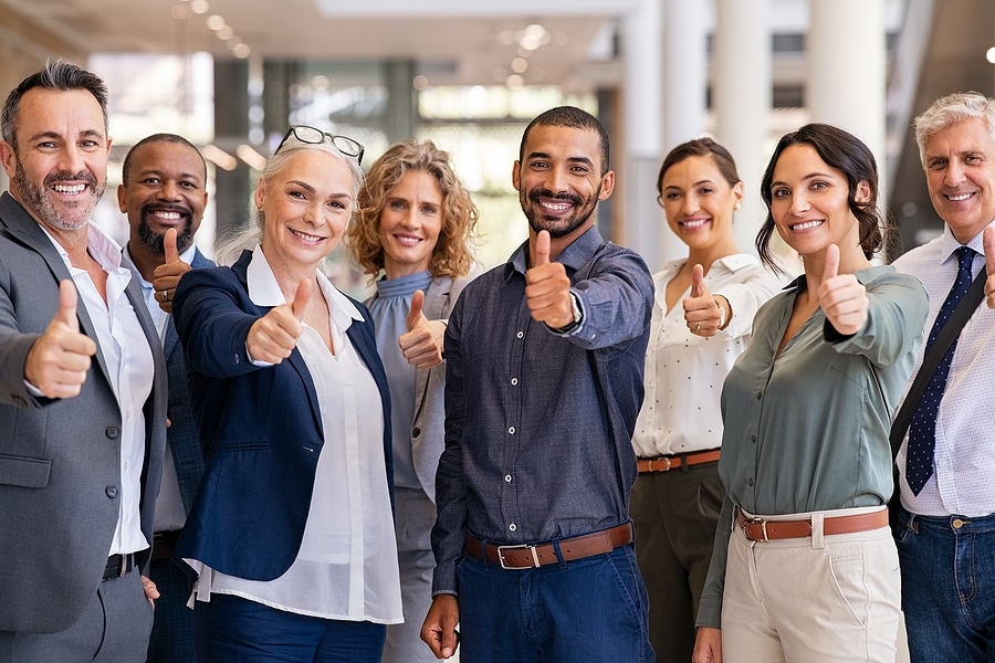 Picture of 8 people giving a thumbs up
